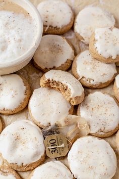 there are some cookies with white frosting on them and a cup of coffee in the background