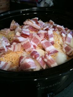 bacon and cheese in a crock pot ready to be cooked