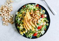 a salad with cashews on the side