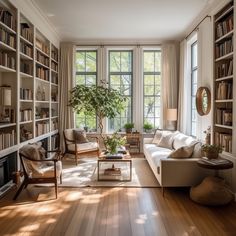 a living room filled with lots of furniture and bookshelves next to a window