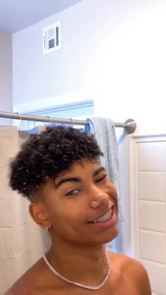 a young man is smiling in the bathroom