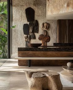 the interior of a modern house with stone sculptures