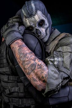 a man wearing a mask and holding his arm up to his face with tattoos on it