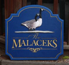 a blue sign with a duck on it's head and the name of its place