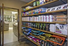 a store filled with lots of different types of food and drink items on wooden shelves