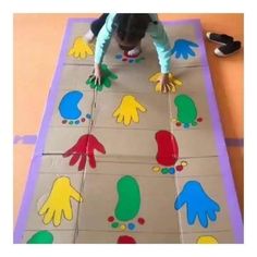 a child is playing with handprints on the floor