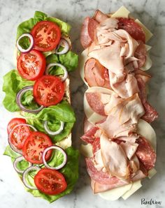 the ultimate party sub with ham, lettuce and tomato slices on it is ready to be eaten