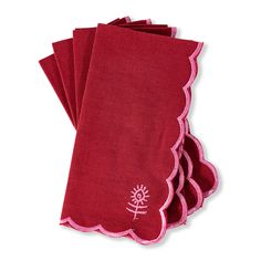 four red napkins with pink scalloped edges