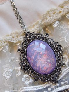 JUST LISTED - Vintage Inspired - Georgian & Victorian Cameo Jewlery - Lavender purple Moonstone FIre Opal OOAK Victorian princess Fantasy glass art Mythical Necklace Altered Art substantial in size at just a little over 2 INCHES Long Center is 40mmx30mm **thank you for taking the time to look at our items. Each item is handcrafted and attention to detail - We send each item in bubble packaging and with tracking to make sure items arrive in perfect condition. Please feel free to check out our Handmade Purple Fantasy Necklaces, Handmade Purple Fantasy Necklace, Purple Handmade Magical Jewelry, Handmade Magical Purple Jewelry, Purple Amethyst Fantasy Jewelry, Purple Fantasy Necklace For Gift, Fantasy Style Purple Amethyst Jewelry, Fantasy Style Amethyst Purple Jewelry, Fantasy Style Purple Necklace For Gift