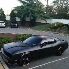 a black sports car parked in a parking lot