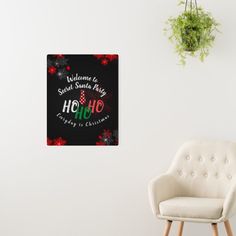 a white chair sitting in front of a wall with a black background and red flowers on it