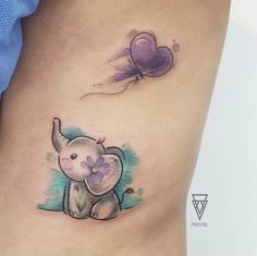 an elephant tattoo on the side of a woman's stomach with a balloon flying above it