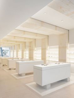 an empty store with white counters and lights