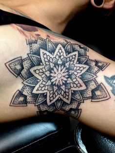 a woman's arm with a tattoo on it and a large flower in the center