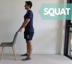 a man standing next to a chair with the word squat on it in front of him