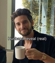 a man holding a coffee cup in his right hand and the words husband reveal real