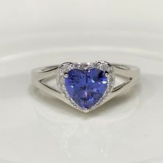 Vintage Sterling Silver Tanzanite & White Topaz Heart Ring ...Marked 925...Total of weights 3.2gramsMeasure of Stone center 6.5MM...Measure of Face 9.2MM....It's in very good condition. Heart Cut Tanzanite Jewelry For Anniversary, Heart Shaped Sapphire Rings For Formal Occasions, Formal Sapphire Heart-shaped Rings, Silver Heart-shaped Birthstone Ring, Heart-shaped Sapphire Jewelry For Anniversary, Sapphire Rings With Heart Cut And Accent Stones, Heart Cut Tanzanite Jewelry Gift, Sapphire Heart Cut Rings With Accent Stones, Heart Cut Topaz Gemstone Ring For Promise