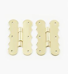 three brass plated door hinges on a white background