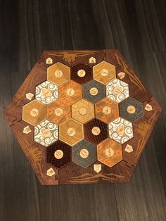 a wooden table topped with lots of different colored hexagons on top of it