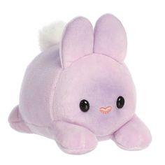 a pink stuffed animal laying on top of a white surface