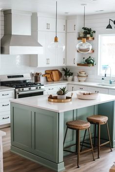 a kitchen island with two stools next to it and an oven in the background