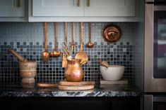 a kitchen counter topped with pots and pans