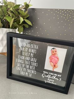 a black frame with a picture of a baby on it