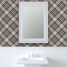 a white sink sitting under a bathroom mirror next to a wall mounted faucet