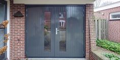 the front door to a brick house with glass panels and sidelights on either side