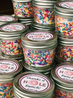 many jars filled with lots of colorful sprinkles on top of each other