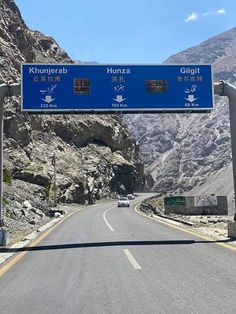 a highway sign on the side of a mountain road