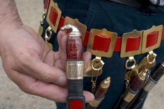 a close up of a person holding a lighter