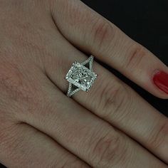 a woman's hand with a diamond ring on it