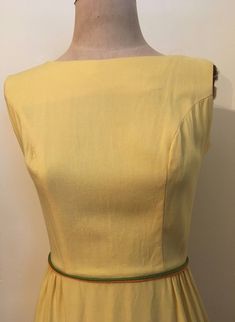 "Bright and beautiful yellow embroidered sleeveless dress from the 1960's is a figure hugging spring essential! Dress is made from a lightweight cotton/rayon and zips up the back with hook and eyes at the waistline and the back of the neck. Dress is in excellent vintage condition. Shoulders 14\" Chest 38\" Waist 25\" Hips 38\" Length from top of shoulder to hem 40\" Armhole 8\" Vintage garments have been previously worn and lovingly cared for, they may however have a blemish or two. Here at Made Fitted Mustard Cotton Dress, Mustard Fitted Cotton Dress, Retro Yellow Cotton Dress, Fitted Yellow Cotton Dress, Fitted Vintage Mustard Dress, Fitted Mustard Dress For Daywear, Yellow Sundress Outfit, Vintage 1960s Dresses, Vintage Blouse Pattern