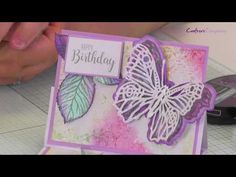 someone is holding up a card with a butterfly on it and the words happy birthday