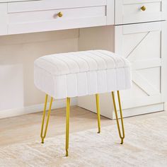 a white bench sitting in front of a mirror on top of a dresser next to a sink