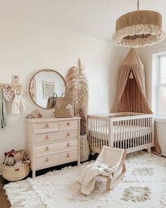 a baby's room with a crib, dressers and a mirror on the wall