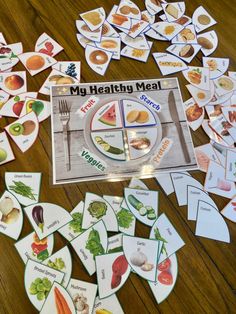 a healthy meal is displayed on a table with matching cards and place mats to match the food