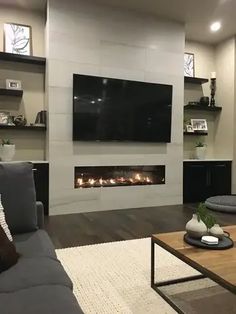 a living room with a couch, coffee table and fireplace