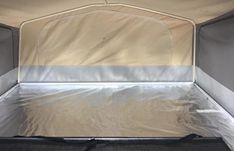 the inside of an enclosed vehicle with aluminum foil covering it's bed and mattress