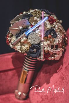 a star wars inspired bouquet with lightsabes and other decorations on it's side