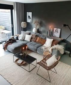 a living room filled with furniture and candles