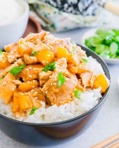 a bowl filled with rice and chicken on top of a table