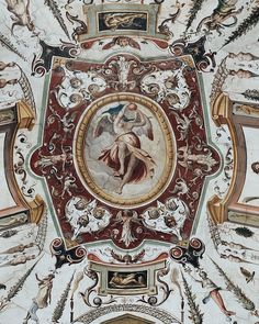 an ornate painting on the ceiling of a building