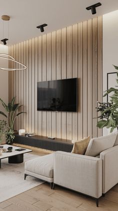 a modern living room with wood paneling and white couches in front of a flat screen tv mounted on the wall