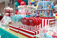 candy bars and lollipops are on display at a circus themed birthday party