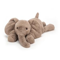 an elephant stuffed animal laying on its side with it's head down and eyes closed