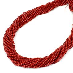 red seed beads on white background with clipping for use in necklaces or bracelets