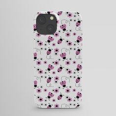 an iphone case with pink and black ladybugs on the front, sitting against a white background