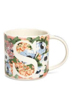 a floral mug with the letter s on it